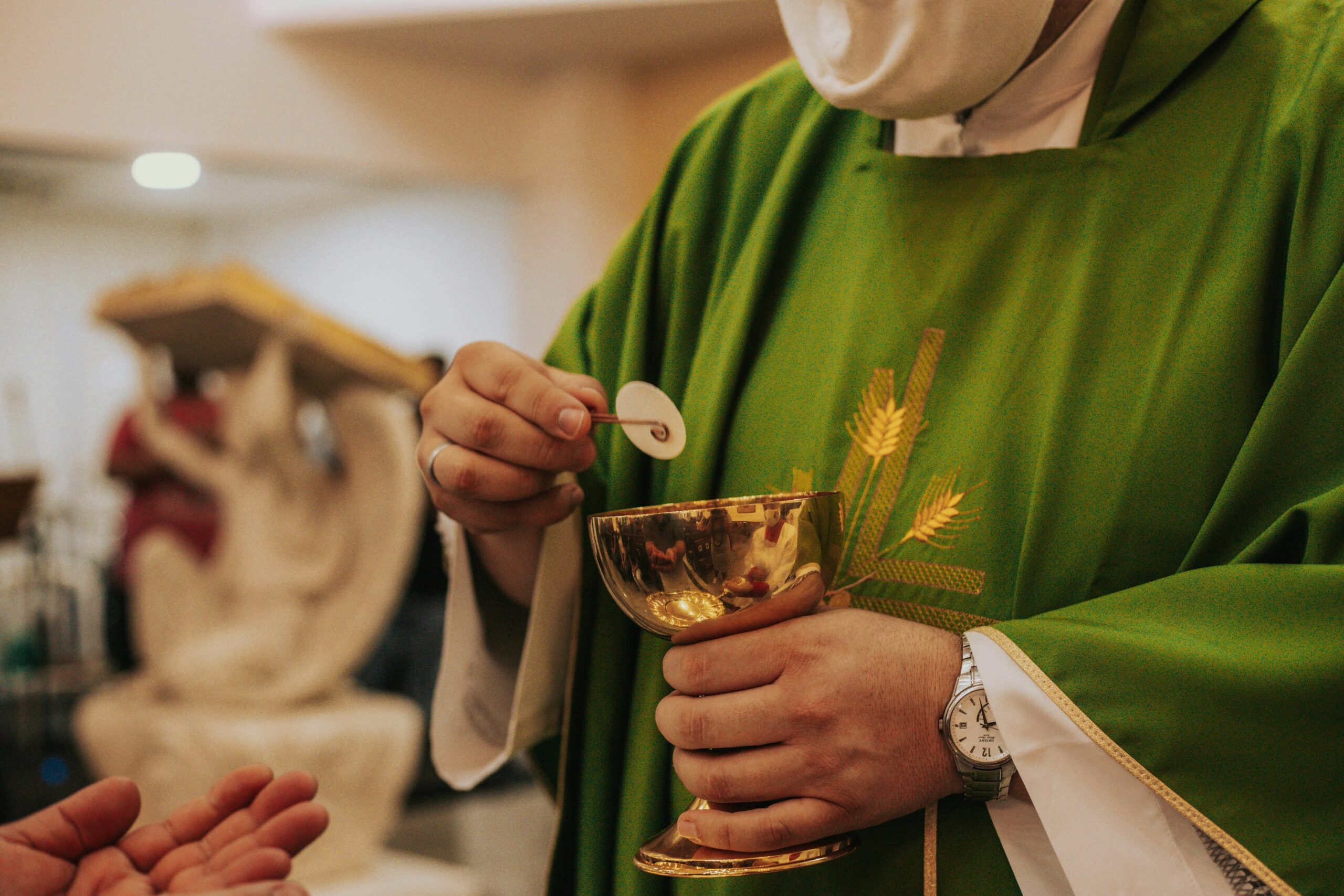 Catholic priest serving the eucharist